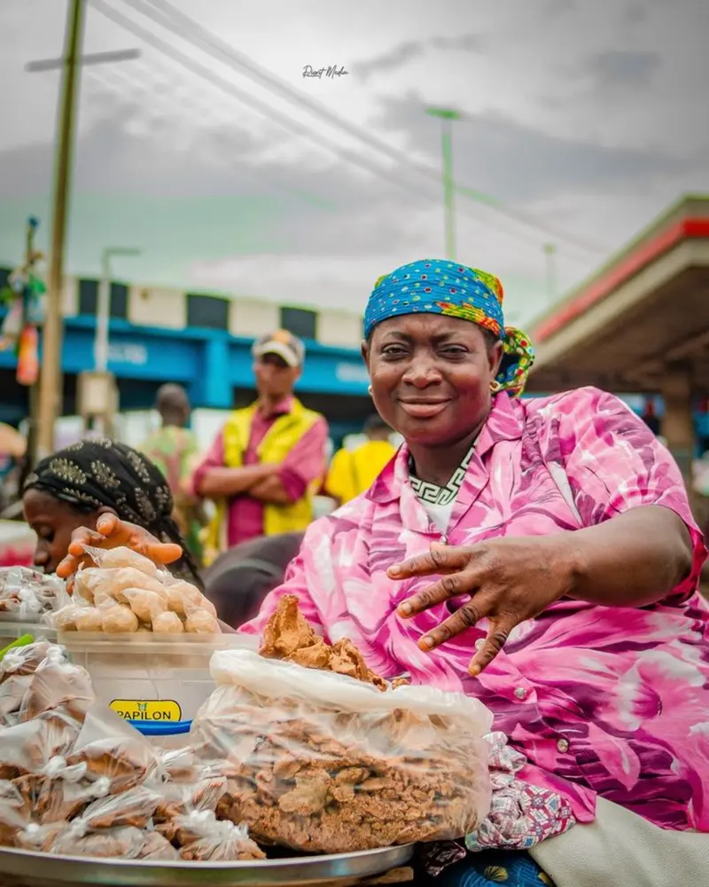 Nigerian woman selling local foodstuff in a market